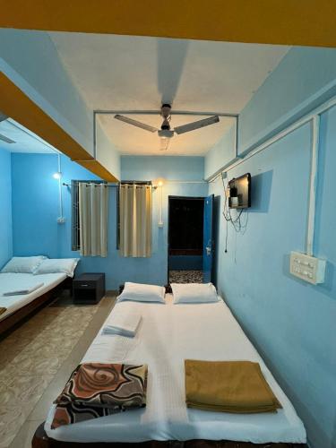 a bedroom with two beds and a ceiling at Casanova by the Sea - Just a walk away to Canacona Beach in Palolem