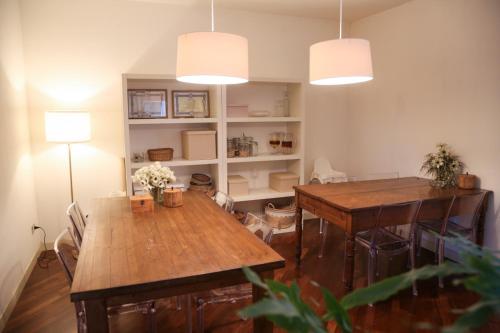 a dining room with two tables and two lights at Pietra E Glicine B&B in Pieve a Nievole