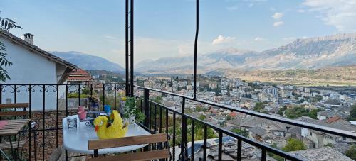 a balcony with a table and a view of a city at Guest House Emily in Gjirokastër