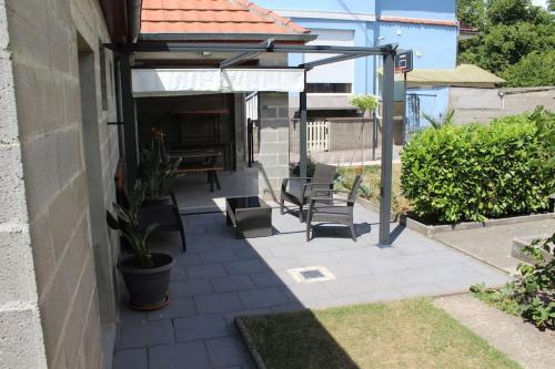 a patio with chairs and a piano on a house at Gîte ''Les Bleuets'' Piscine été 2026 in Scherwiller