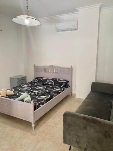 a bedroom with a bed and a couch at Kalamaki Philoxenia in Athens
