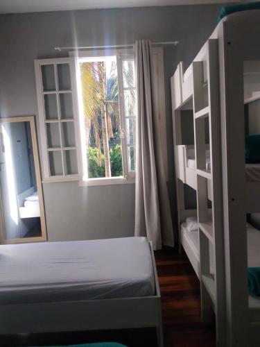 a bedroom with a bunk bed and a window at Hotel Cidade Imperial in Petrópolis