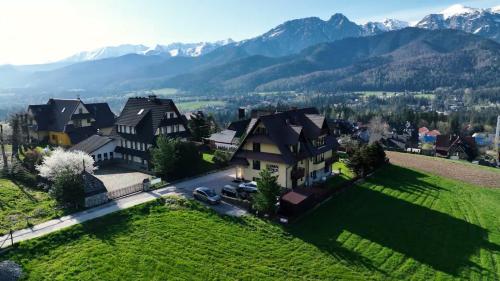 an aerial view of a house with mountains in the background at Panorama Premium in Kościelisko