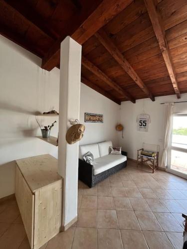 a living room with a couch and a table at Attico Surfhouse Mistral Estoril in Sal Rei