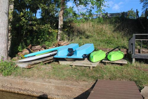 a group of surfboards sitting on pallets in the grass at The Lake Barndominium in Delton