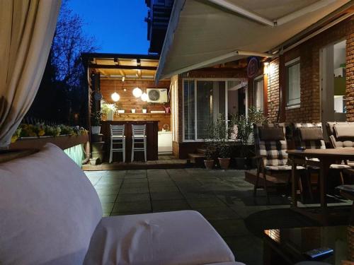 a patio with a table and chairs and a house at Modern Retreat in Skopje