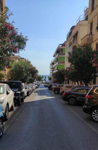 a street with a bunch of cars parked on the road at Alloggio al binario 9 e tre quarti in Civitavecchia