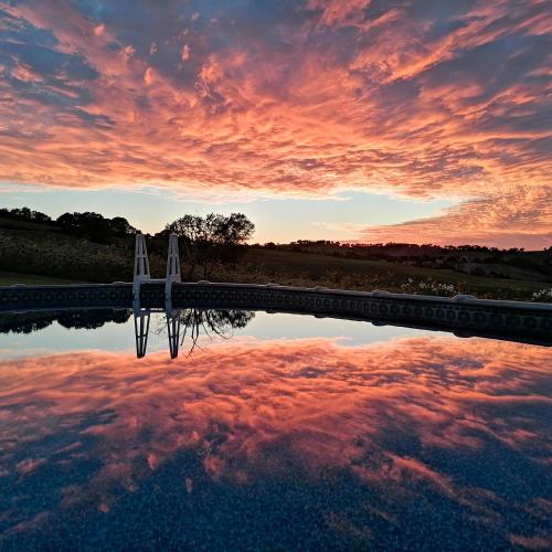 a reflection of the sky in a body of water at Il Giardino nella Valle in Belvedere Ostrense