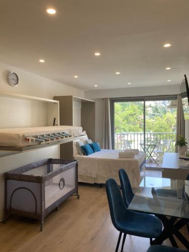 une grande chambre avec un lit et un balcon dans l'établissement Studio La Cigale bord de mer, à Menton