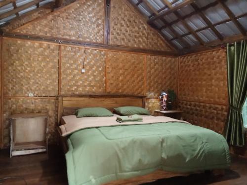 a bedroom with a large bed in a room at Jonny's Places in Tetebatu
