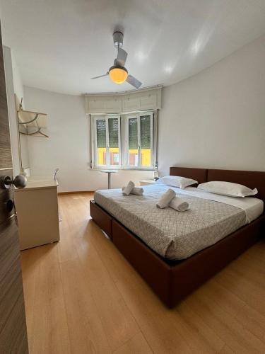 a bedroom with a large bed with a ceiling fan at Hotel Locanda Castagnola in Lugano