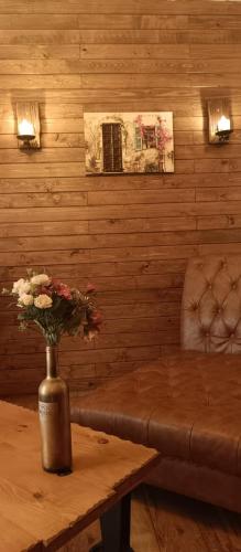 a vase of flowers on a table in a room at Rokwood faraya in Ash Sha‘rah