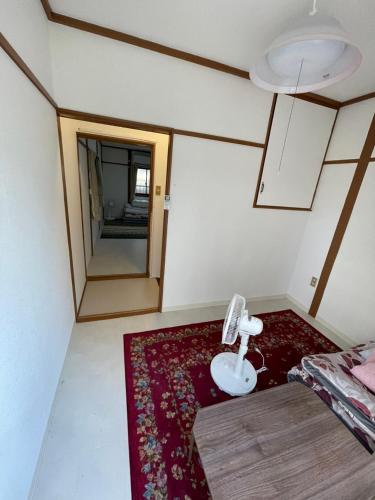 a room with a bed and a red rug at AnNam Stay Osaka Airport - whole two story house rental in Toyonaka