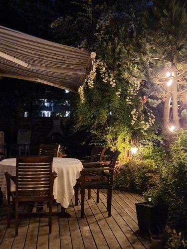 a table and chairs on a patio at night at Luxury Villa, geothermal hot tub, for 8 person in Hafnarfjördur