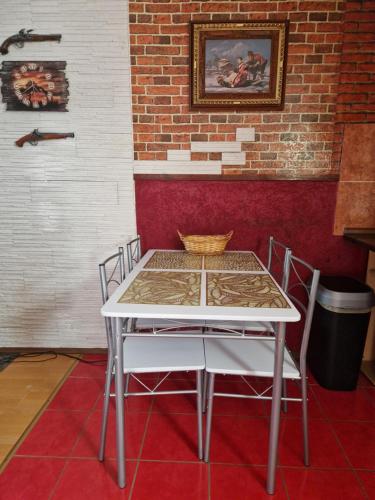 a table and chairs in a room with a brick wall at Haus Melzer in Öhringen