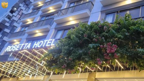 a hotel with a sign on the side of it at Rosetta Hotel Phu Quoc in Phu Quoc