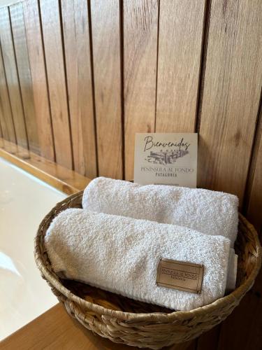 a basket filled with towels on top of a table at Suite del muelle in San Carlos de Bariloche