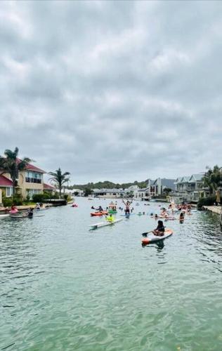 a group of people kayaking on a body of water at Jeffreys Bay - Life on the Canals in Jeffreys Bay
