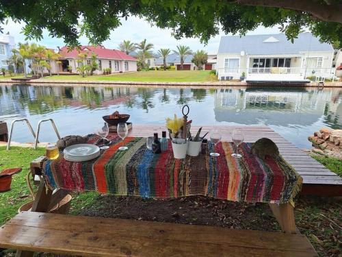 a picnic table in front of a pool of water at Jeffreys Bay - Life on the Canals in Jeffreys Bay