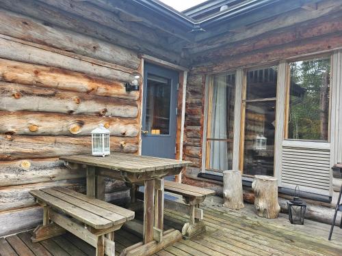 un tavolo da picnic sul portico di una baita di tronchi di Salmikankaankelo C4 a Ruka