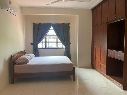 a bedroom with a bed and a window at Bangi in Kajang