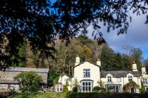 a large white house with a hill in the background at Lancrigg in Grasmere