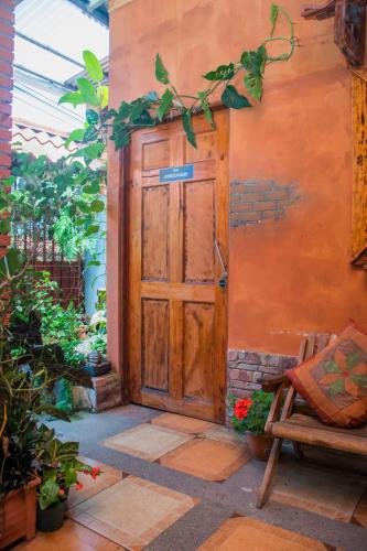 an entrance to a house with a wooden door at Gardens House, Airport Juan Santamaría, Alajuela, San José in Alajuela City