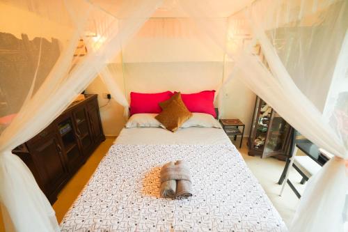 a bedroom with a bed with a canopy at Hidden Haven - The Goan Getaway in Dhamni