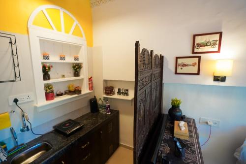a bathroom with a sink and a counter top at Hidden Haven - The Goan Getaway in Dhamni