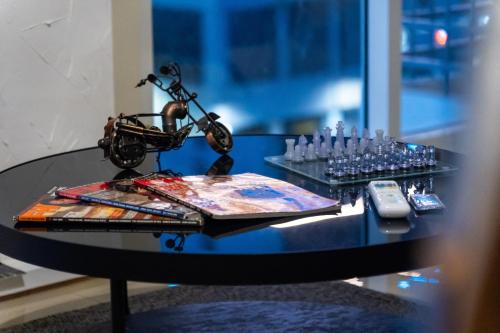 a black table with a motorcycle on top of it at Luxury Condo Ocean View 1,2,3, & 4 Bedrooms Infinity Pool Gym Spa Next to Okada Solaire MOA NAIA Airport in Manila