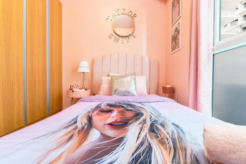 a bed with a painting of a woman on it at Luxury Condo Ocean View 1,2,3, & 4 Bedrooms Infinity Pool Gym Spa Next to Okada Solaire MOA NAIA Airport in Manila