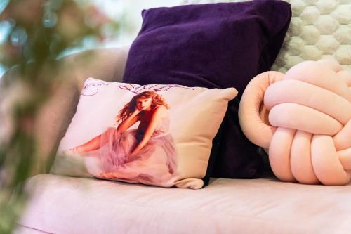a pillow with a woman in a dress sitting on a couch at Luxury Condo Ocean View 1,2,3, & 4 Bedrooms Infinity Pool Gym Spa Next to Okada Solaire MOA NAIA Airport in Manila