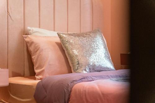 a bed with a sequin pillow on top of it at Luxury Condo Ocean View 1,2,3, & 4 Bedrooms Infinity Pool Gym Spa Next to Okada Solaire MOA NAIA Airport in Manila