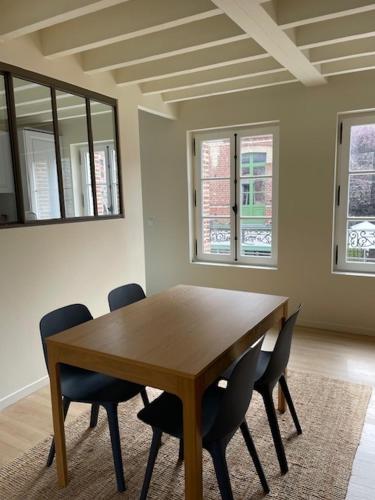 - une table et des chaises en bois dans l'établissement Le fournil, à Veules-les-Roses