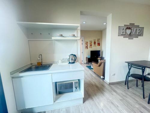 a kitchen with a sink and a table in a room at Minimal 2 BR next to IKEA, Central Westgate Bangyai in Ban Bang Krabu