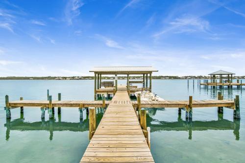 a dock with a gazebo on a body of water at Lagoon Landing 207- Best of beach & lagoon in Gulf Shores