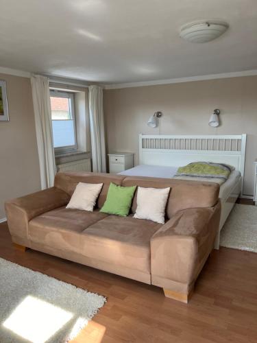 a living room with a couch and a bed at Allgäu Apartment in Memmingen