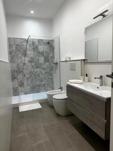a bathroom with a sink and a toilet and a shower at Black Daisy in Bernalda