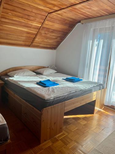 a bed in a room with blue napkins on it at Tágas hely a parton in Balatonszárszó