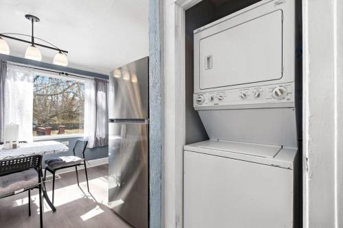 a kitchen with a refrigerator and a dining room at Jazzy Charmer with 3 Queen BedsJazzy Charmer in Kansas City