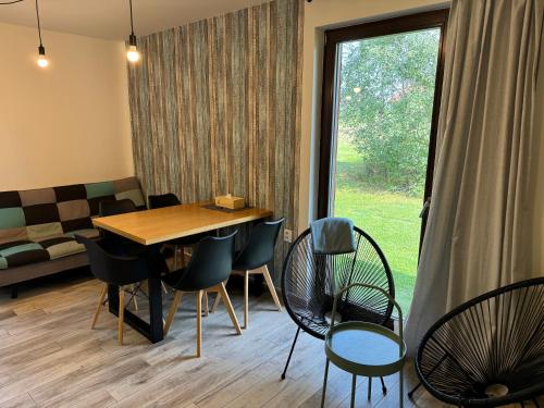 a room with a table and chairs and a window at Apartmány Černý vlk, Borová Lada in Borová Lada