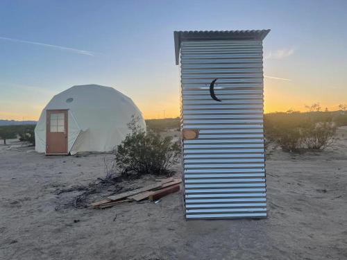 a tent and a dome in the desert at Geodesic Dome for Glamping in Sunfair Heights