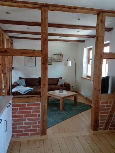 a living room with a couch and a table at Ferienwohnung Gisela 80qm in Gernrode - Harz