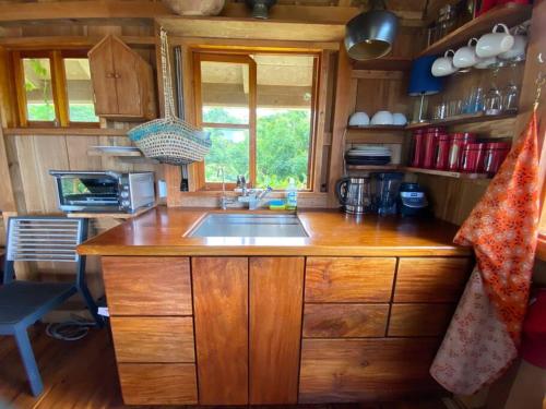a kitchen with a sink and a wooden counter top at Magical Port Antonio Close to Blue Lagoon Frenchman's Cove in Port Antonio