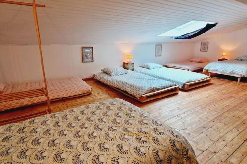 a room with four beds in a room at Gite La Planquette - Piscine - Spa - Pétanque in Saint-Laurent-de-Médoc