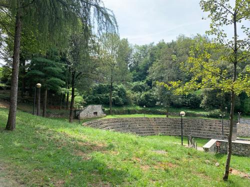a stone amphitheater in a park with trees at Il Sogno di GioEle in Borgo San Dalmazzo