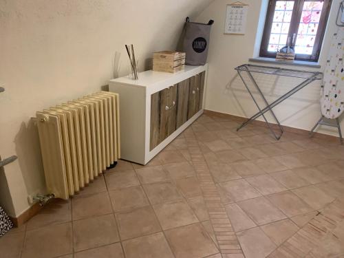 a living room with a radiator and a tiled floor at Il Sogno di GioEle in Borgo San Dalmazzo