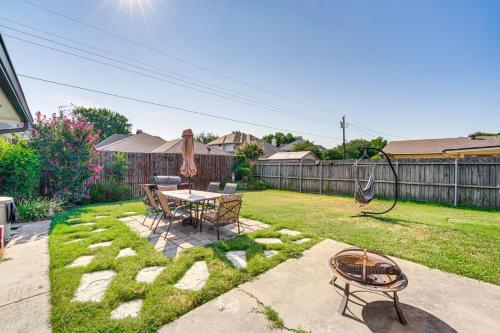 a backyard with a table and chairs and a grill at Texas Home with Yard 2 Mi to Prairie Creek Park in Richardson