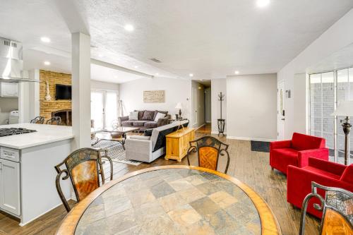 a kitchen and living room with red chairs and a table at Texas Home with Yard 2 Mi to Prairie Creek Park in Richardson