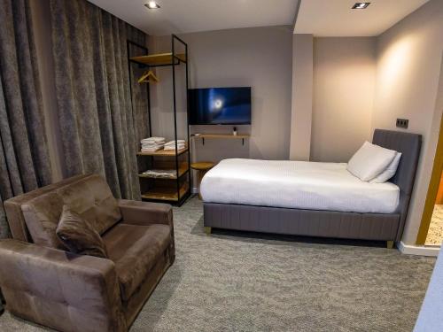 a hotel room with a bed and a couch at Taksim REXXEE Istanbul Istiklal Hotel in Istanbul